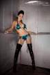 Tehmeena-Afzal-leaning-against-the-wall-wearing-a-turquoise-bikini-and-long-black-boots.jpg